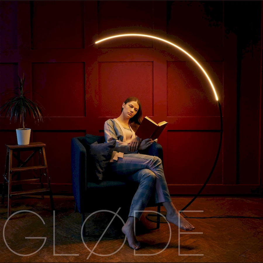 Современный торшер ArcOsmo с дугообразной алюминиевой стойкой в интерьере гостиной